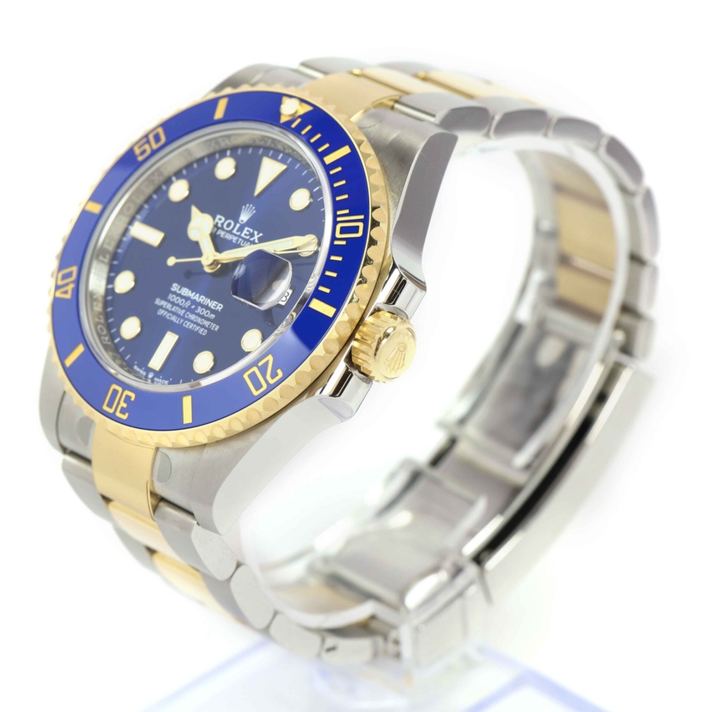 Rolex Submariner watch featuring a two-tone design with a blue bezel and dial, gold accents, and a stainless steel and gold oyster bracelet.