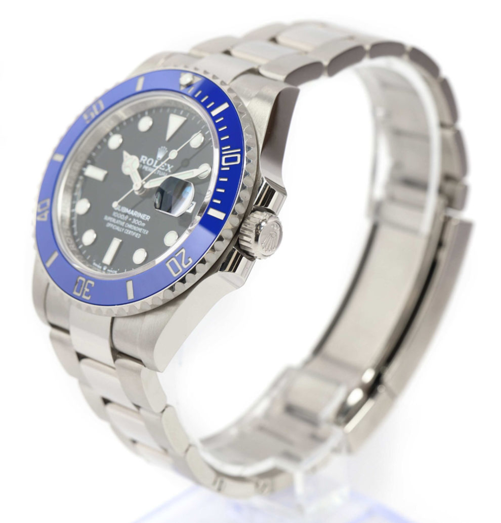 Rolex 'Cookie Monster' Submariner watch featuring a blue ceramic bezel, black dial, and stainless steel bracelet, displayed at an angle to highlight its design.