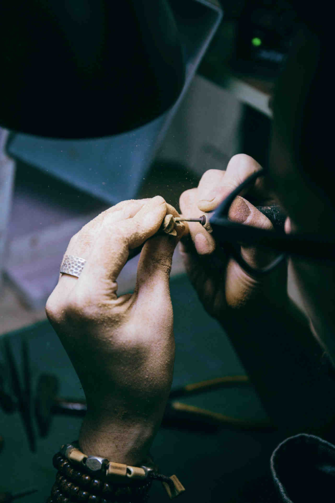 Jeweler carefully polishing a ring during a jewelry repair process in Philadelphia